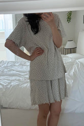 Mirror selfie of mom wearing AVAUMA Berry Cream short-sleeve pajama set
